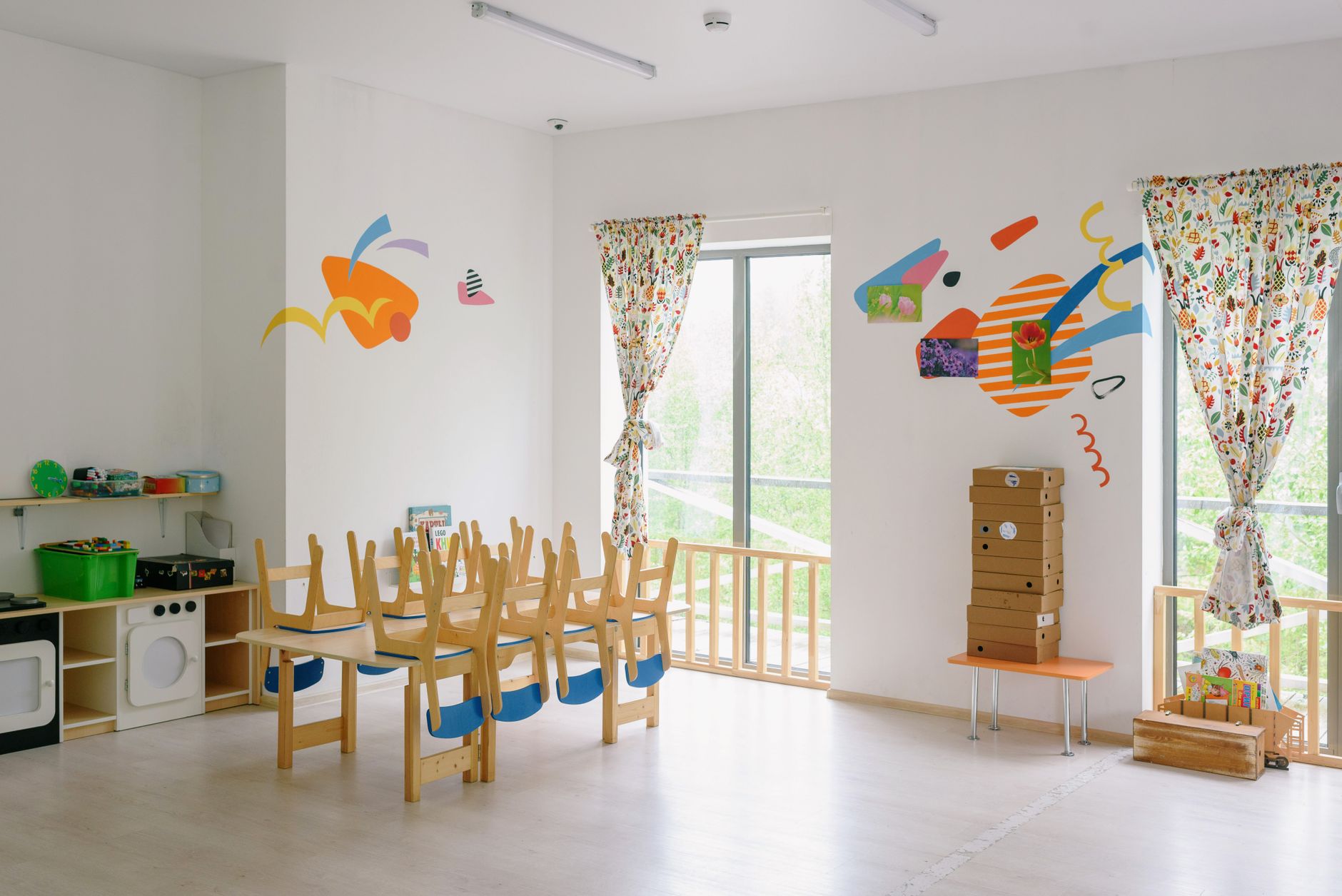 A bright, calm classroom with simple wooden furniture and soft natural light